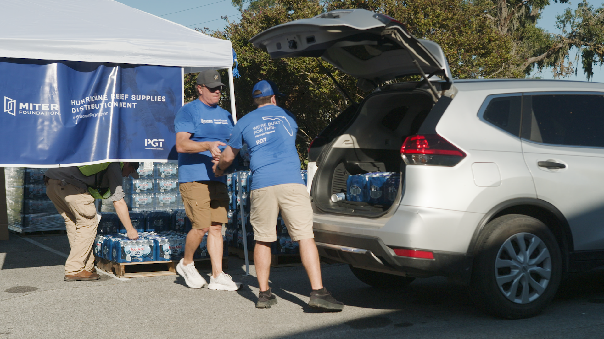 Team members load supplies into a vehicle at the Hurricane Helene relief event.